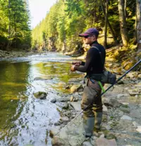 man fly fishing in a lake