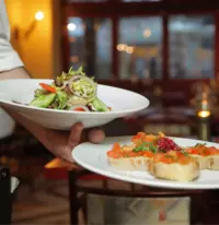 two plates of food being served at a restaurant