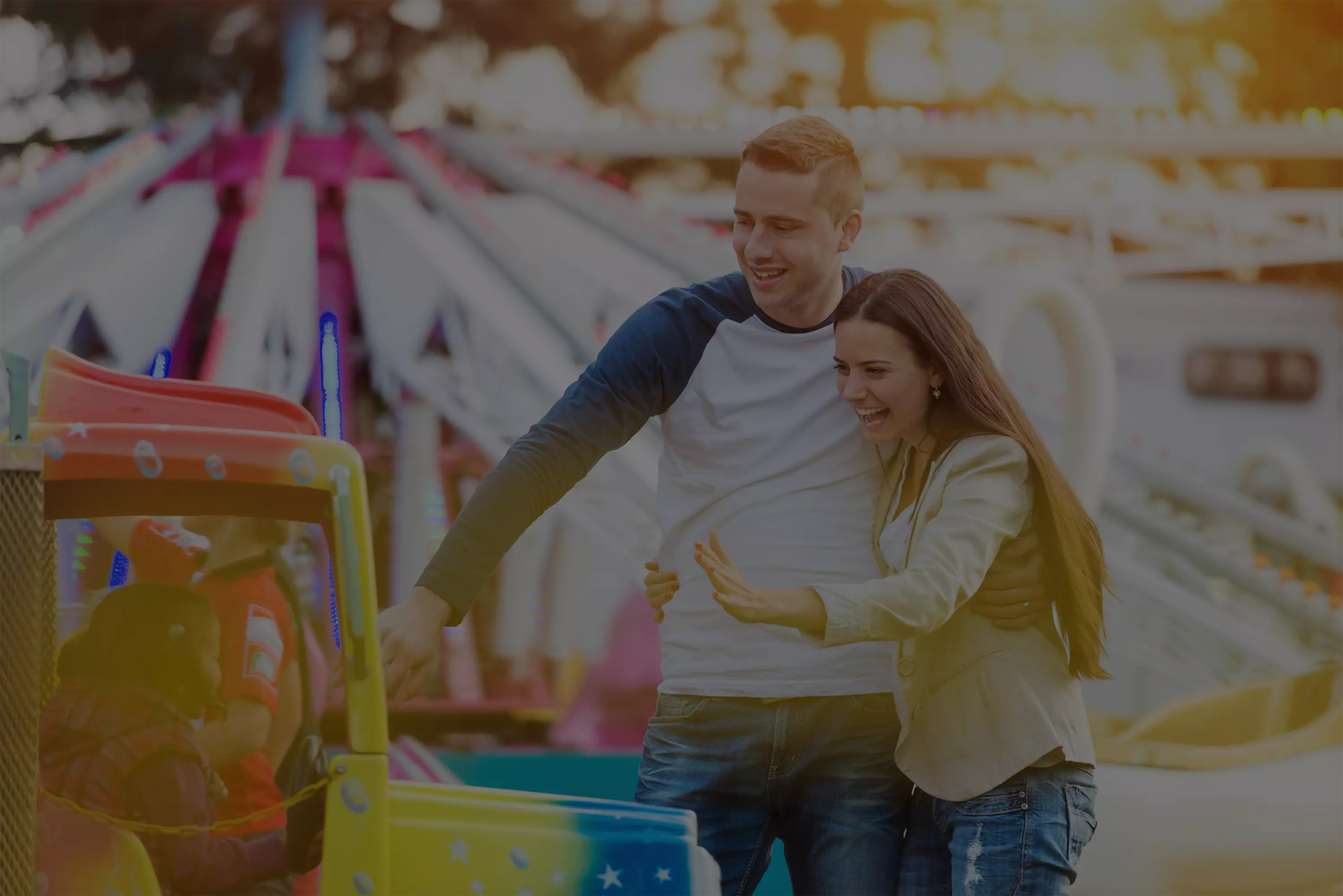 couple playing with children on carnival ride