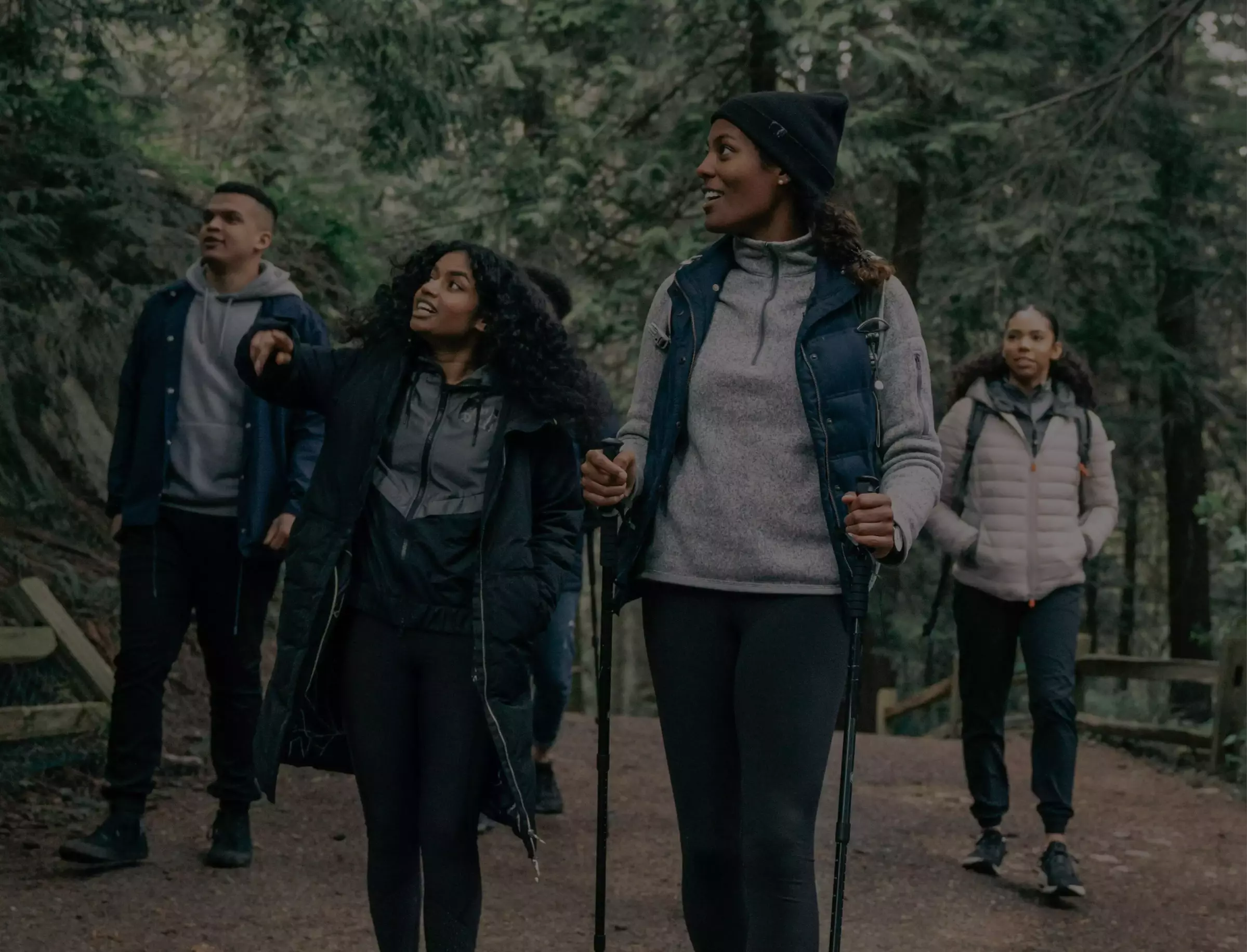 group of people hiking through the woods