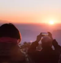 couple taking picture of sunrise